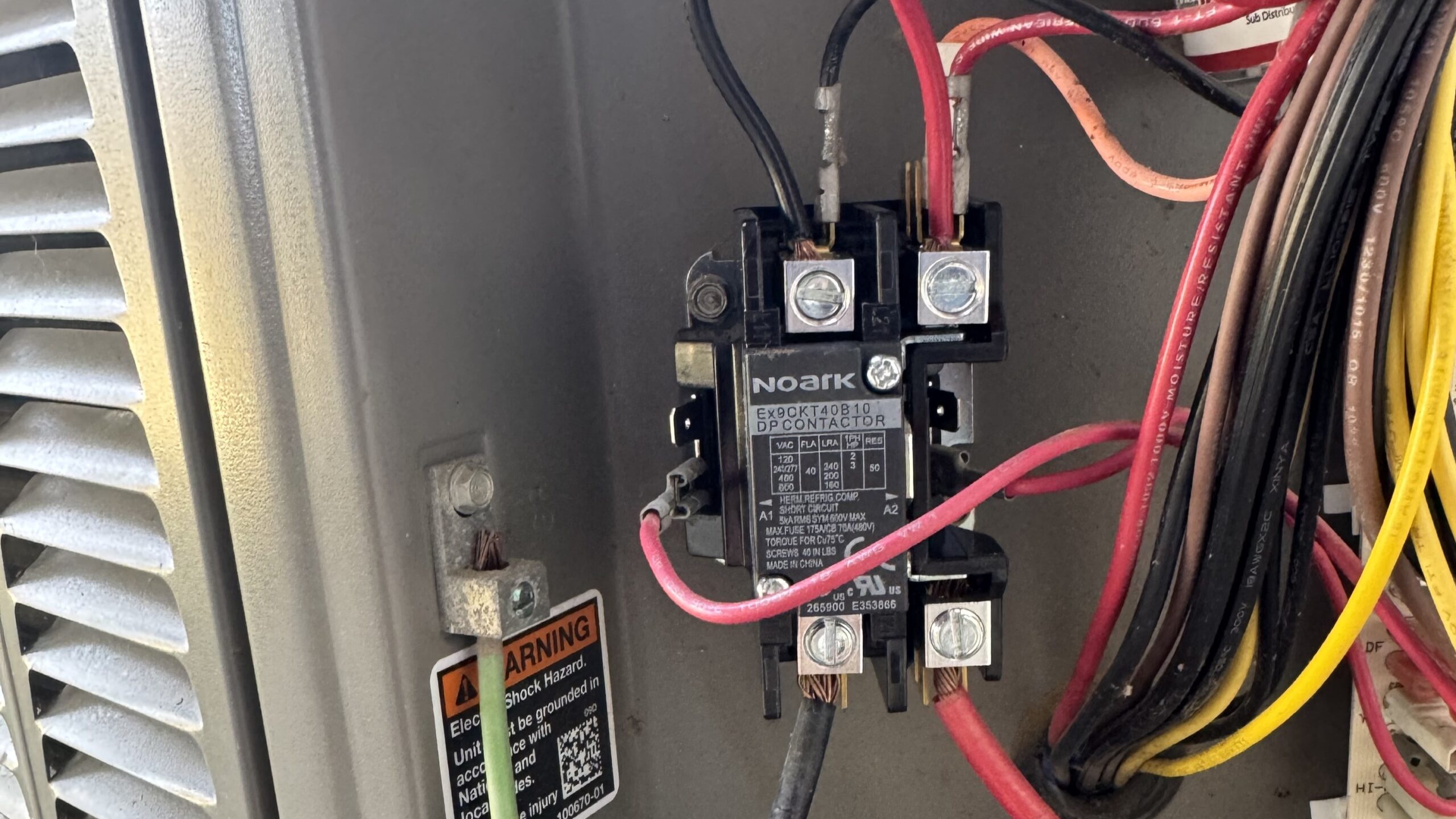 Close view of an AC contactor. A faulty contactor could be why your ac keeps shutting off in your NY home