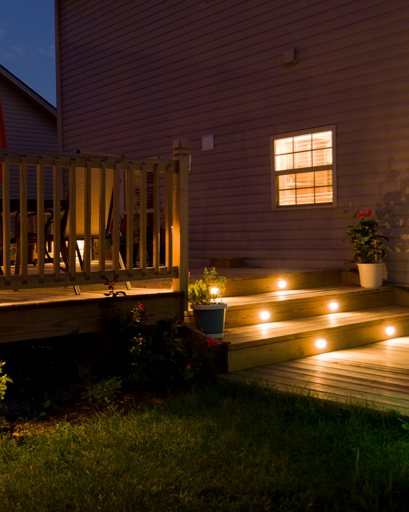 Deck of home with outdoor lights installed