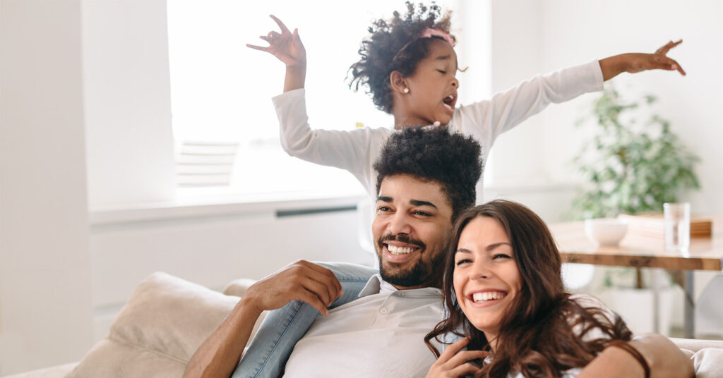 Family lifestyle portrait of a mum and dad with their kid