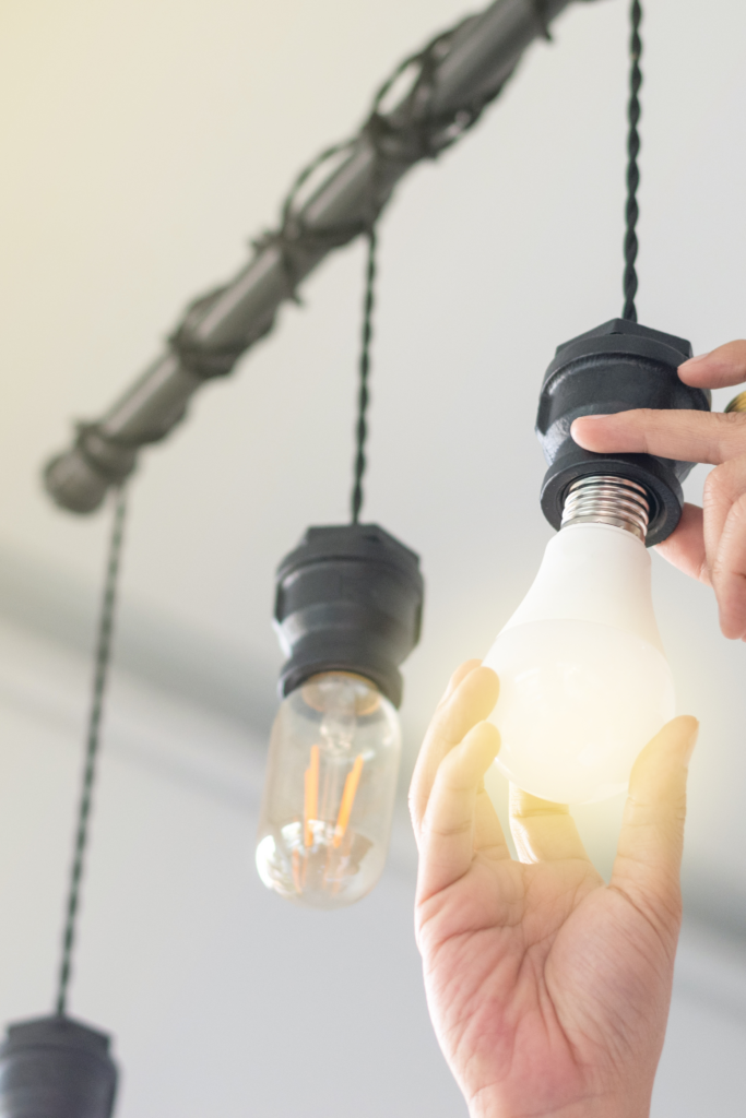Person screwing in lightbulb