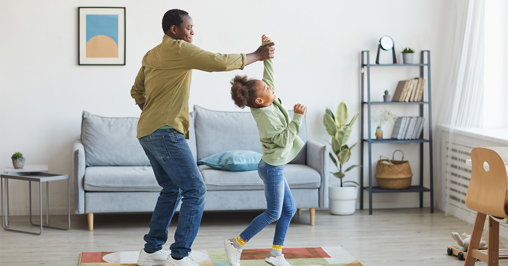 Family dancing together in living room