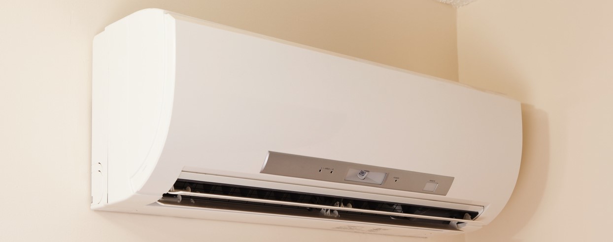 A wall-mount mini-split heating and air conditioning unit installed in a new house. A modern heat pump, this unit heats a house in winter and cools in the summer. This type of system eliminates ductwork which is a primary source of inefficiency in a conventional system making this about 30% more efficient. This particular unit has an eye sensor which pans the room looking for hot or cold spots and directs the airflow accordingly.