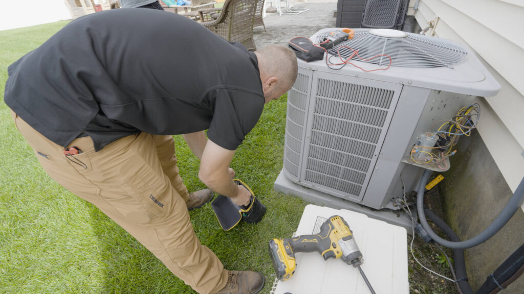 HVAC technician installing Carrier Central Air System