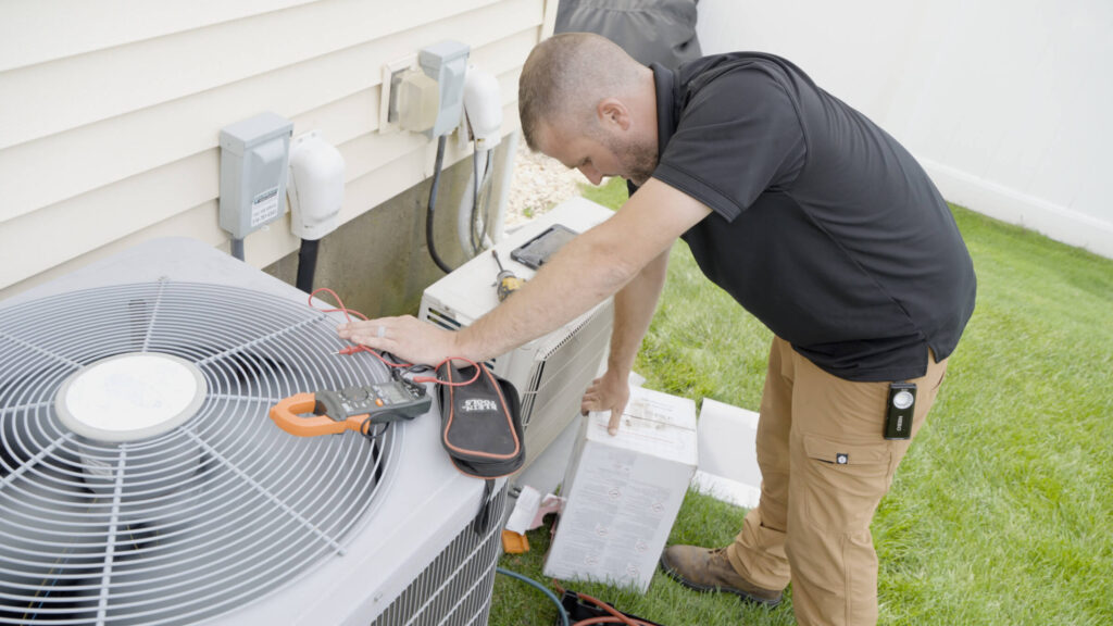 HVAC technician installing Carrier Central Air System