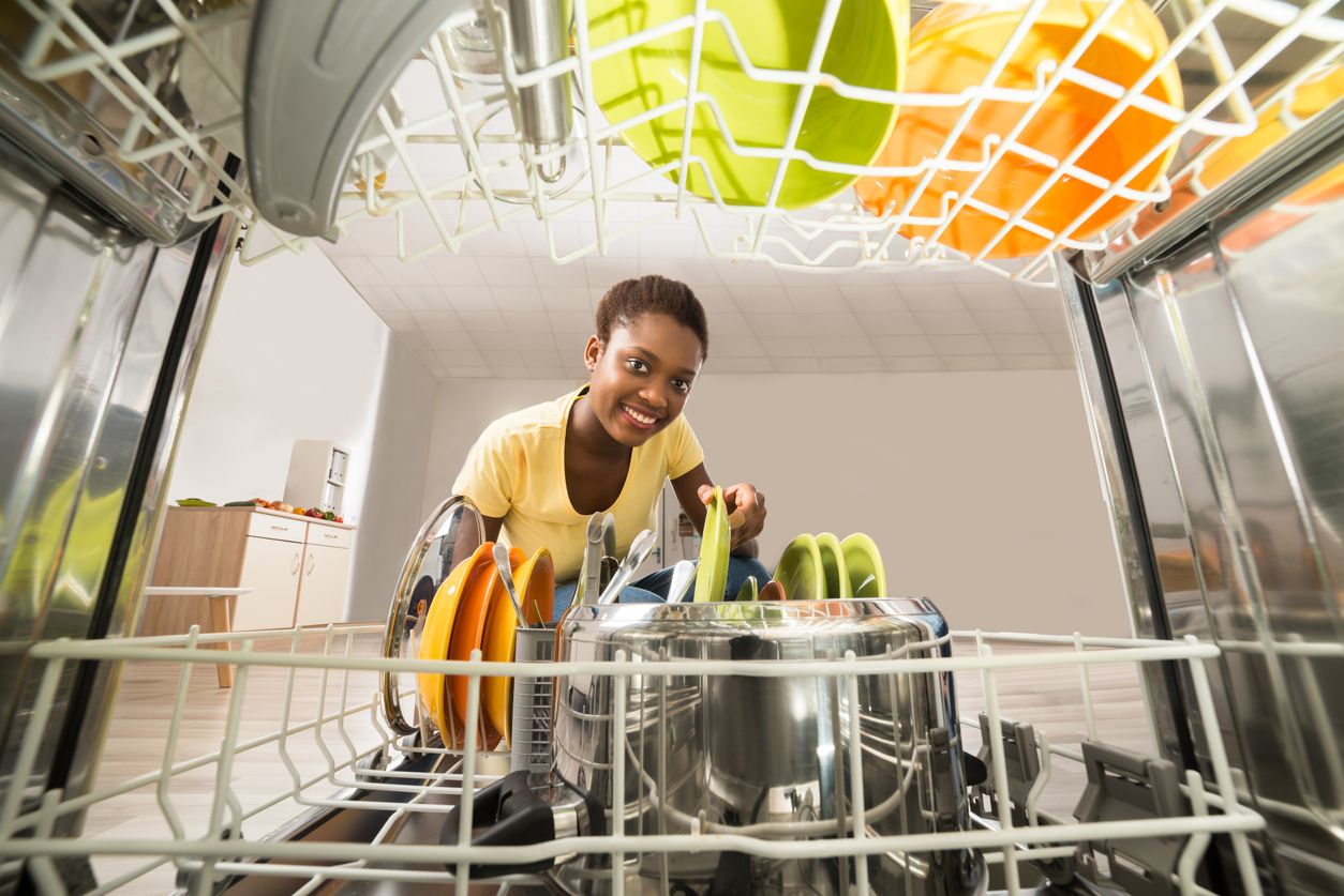 Woman unloading dishwaher
