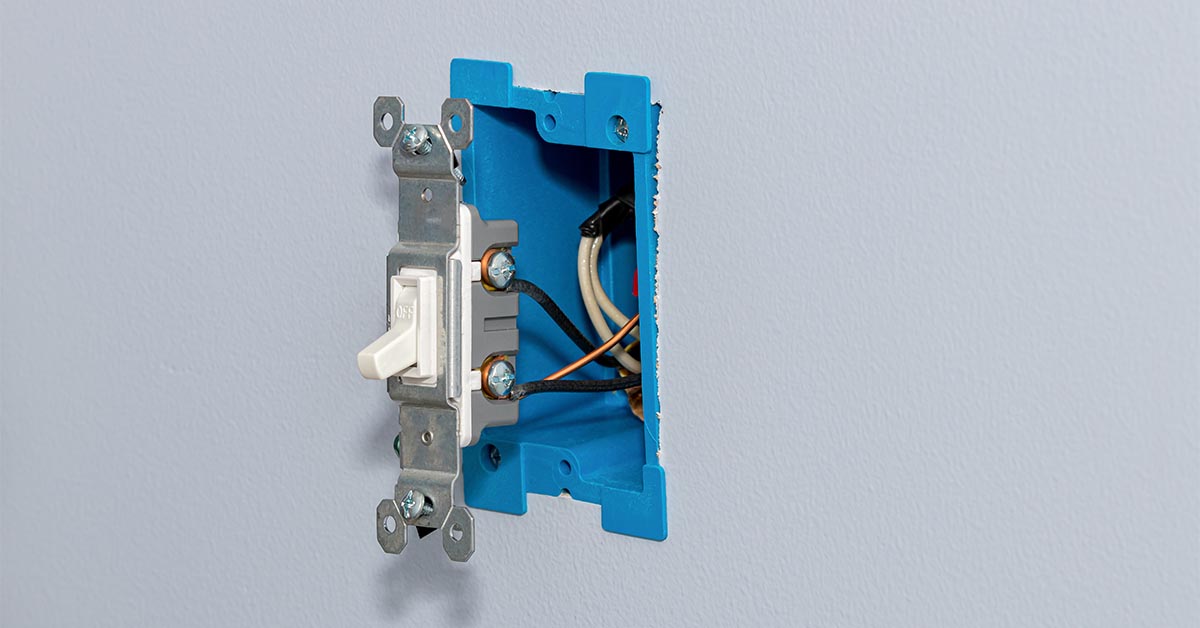 White electrical light switch and wiring in wall