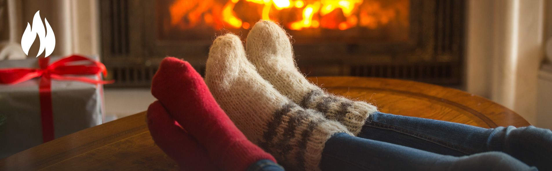 People warming feet near fireplace