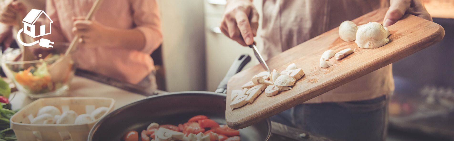 Person adding sliced vegetables to a pan