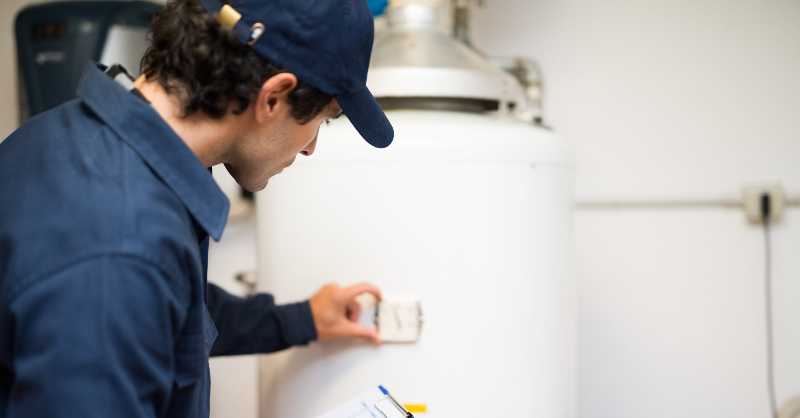 plumber inspecting a water heater