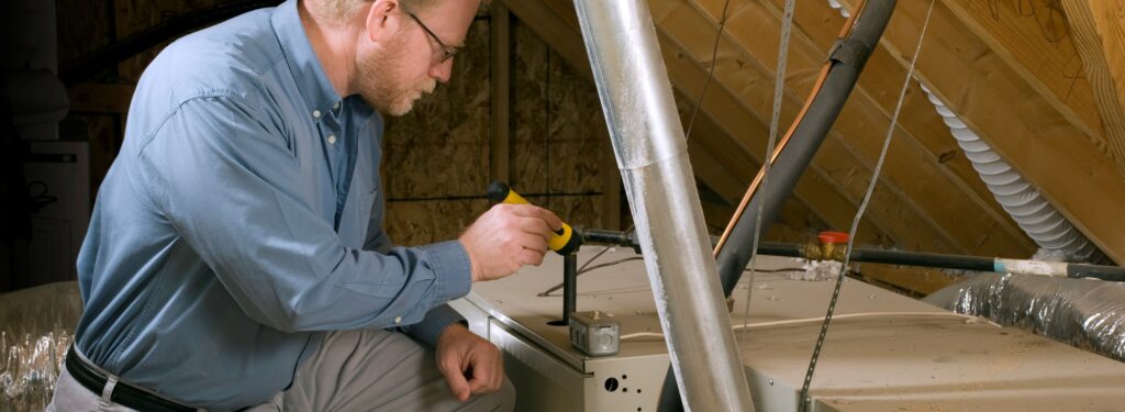 Service Man Inspects Furnace