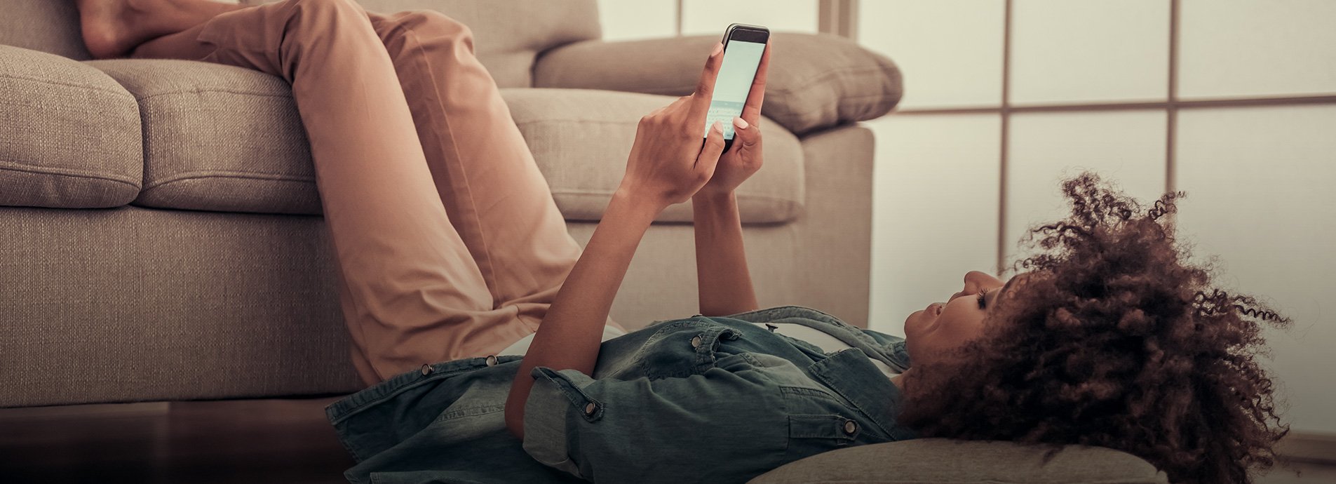 woman relaxed on her phone laughing