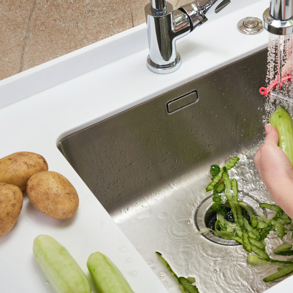 Food waste disposer machine in sink in kitchen