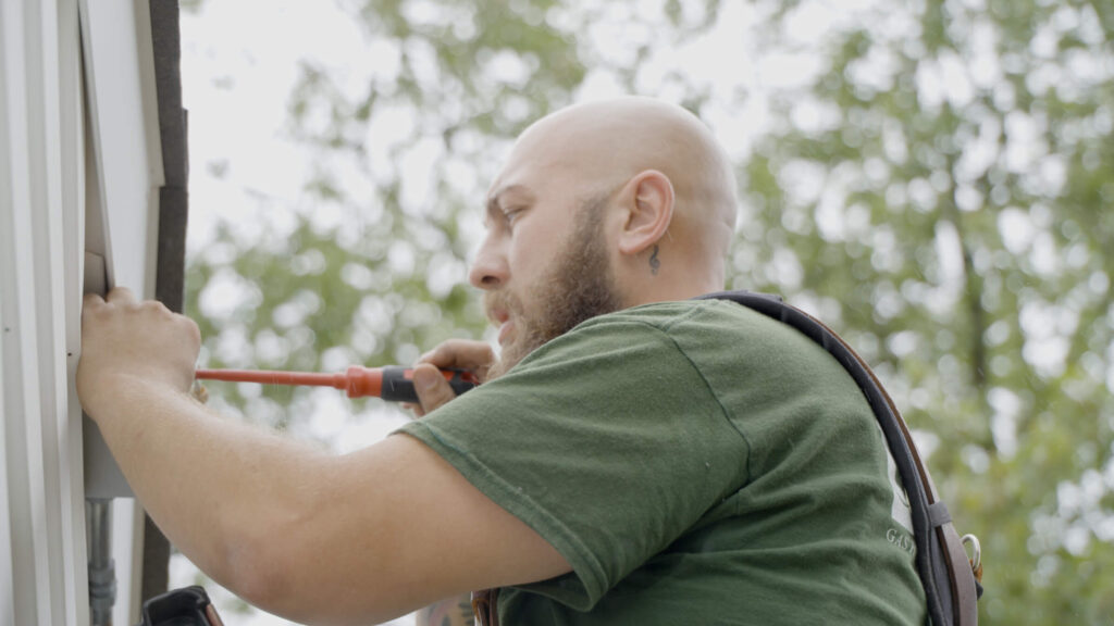 Universe technician installing outdoor lights
