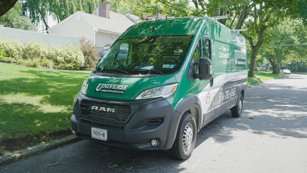 Green Universe Van parked on the side of residential street