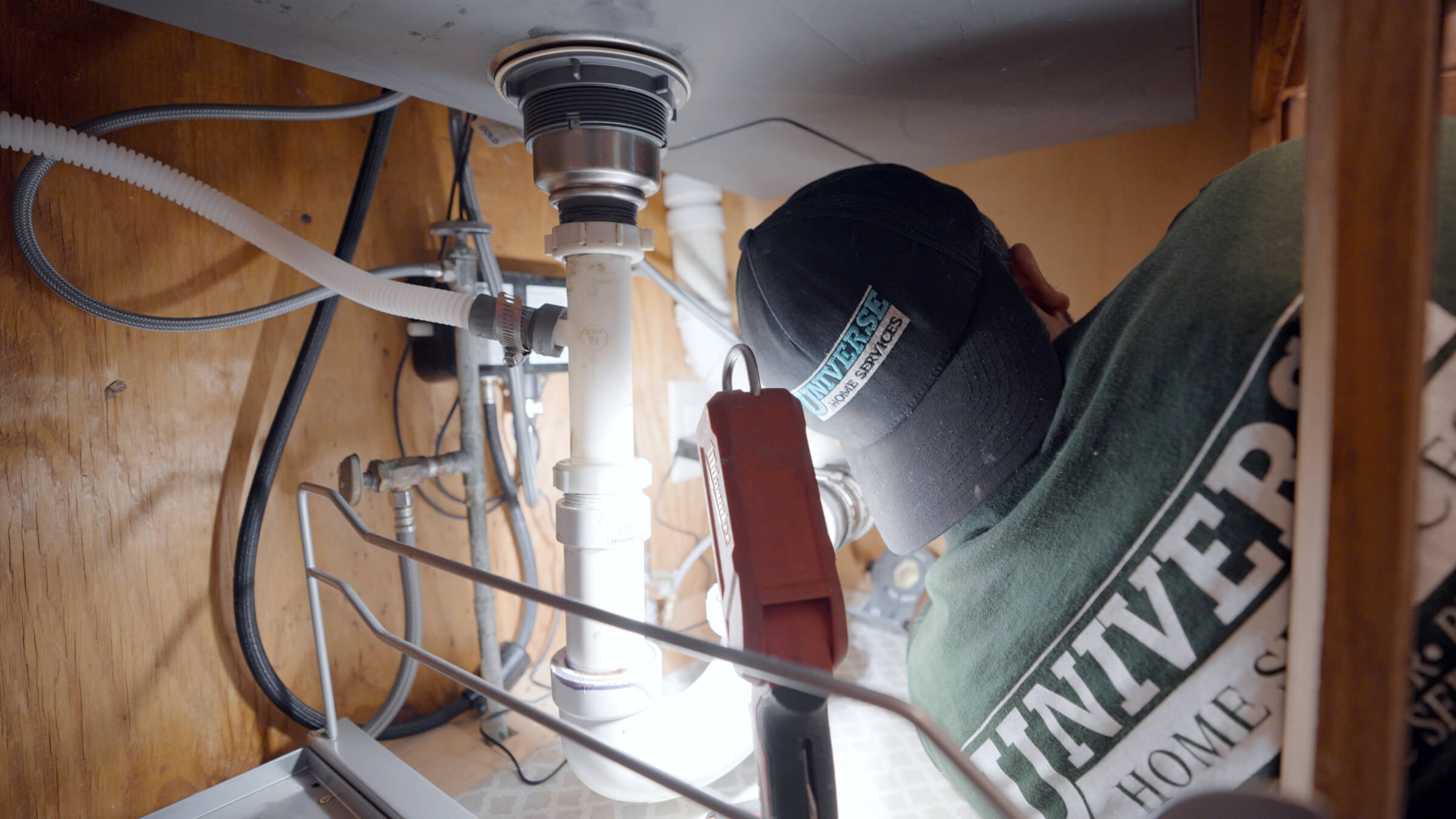 Technician inspecting residential HVAC ductwork for airflow efficiency