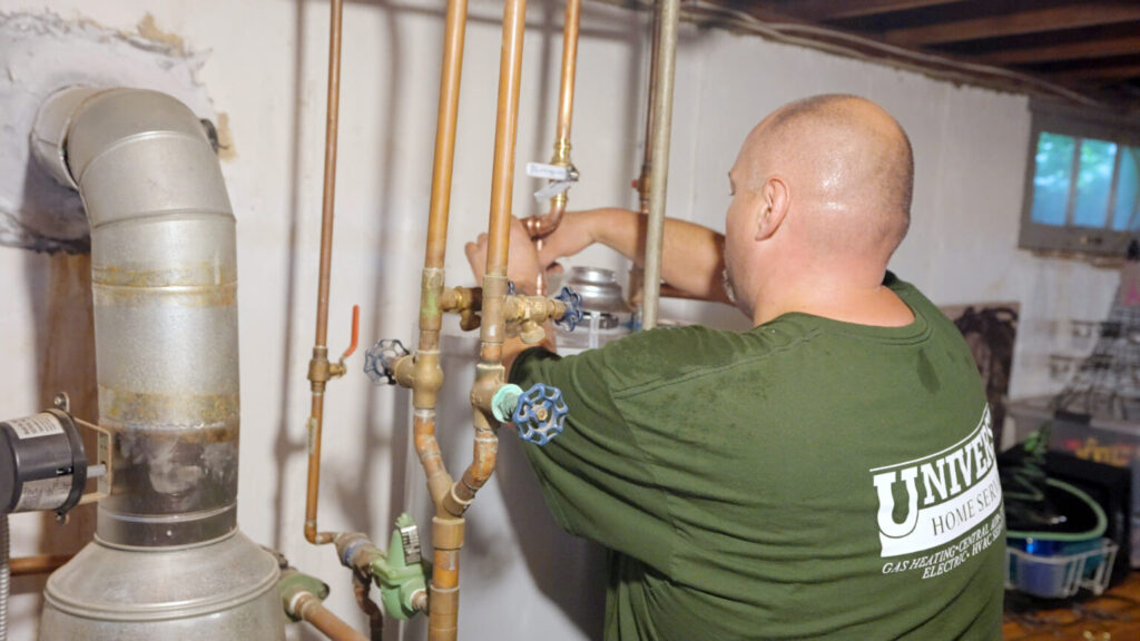 Universe technician installing water heater